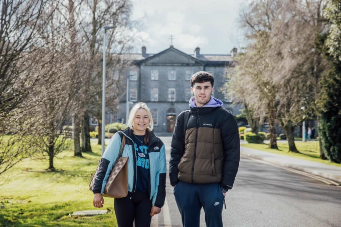 Two MIC students standing outside MIC Thurles