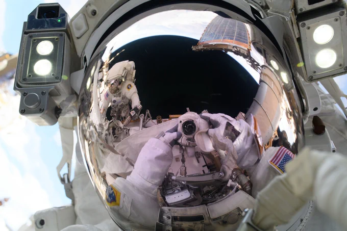 Astronaut Anne McClain takes a selfie during a spacewalk. The camera and fellow astronaut Nichole Ayers are visible in her visor's reflection. Credit: NASA/Anne McClain