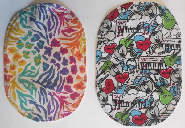 Two stoma bag covers, one with a rainbow floral pattern and the other showing keyboards and guitars.