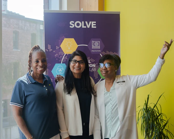 Dr. Divya McMillin posing with IBJ Founder Carol Mitchell and Melannie Cunningham
