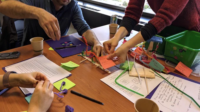 UW Colab team prototyping with pipe cleaners, popsicle sticks, playdough, and more!