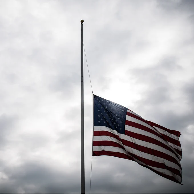American flag being flown at half staff