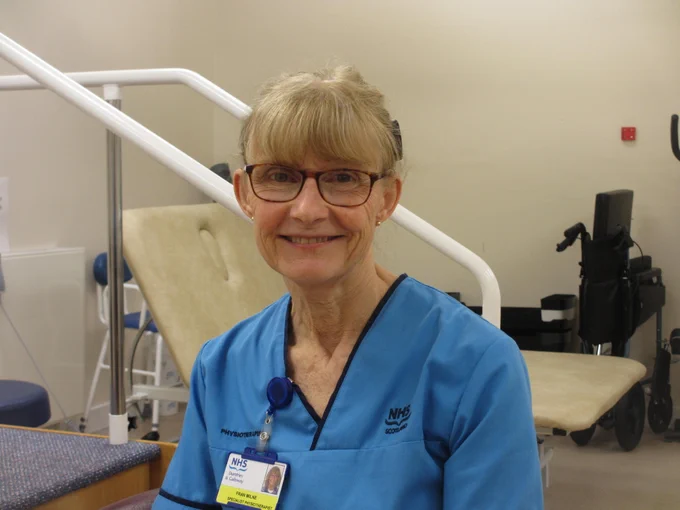 Photo of Fran at work smiling at the camera.