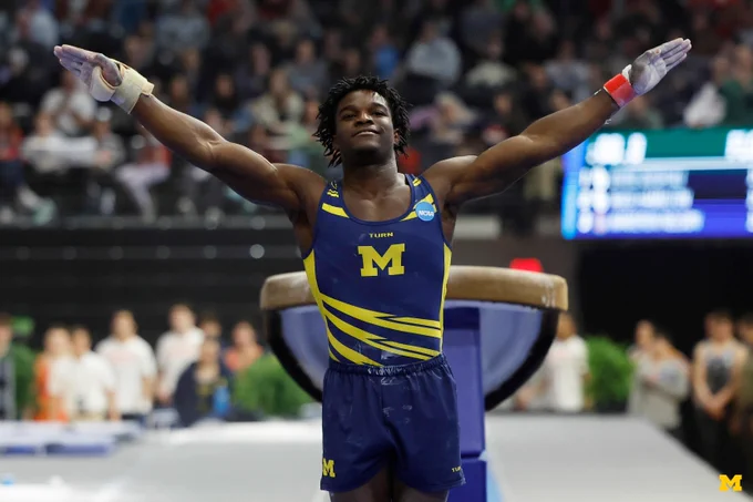 Fred Richard celebrates after a routine in competition with Michigan Men’s Gymnastics.