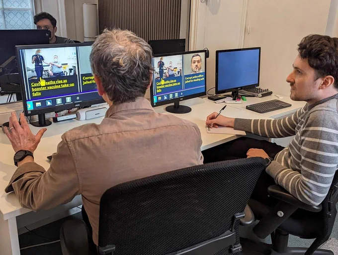 Two people conducting a usability testing in which the participant is using a screen magnifier to enlarge text