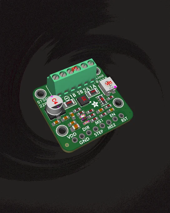 A small green STSPIN220 motor driver board with labeled pins, components, and terminal blocks for stepper motor control.