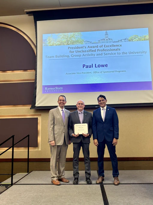 Marshall Stewart, Paul Lowe and Provost Mendez on the awardee platform at the All University Awards Ceremony.
