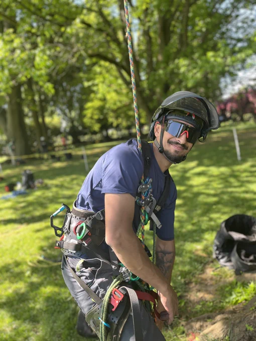 Arborist Trainee posing for a picture while in full gear for going up a tree.