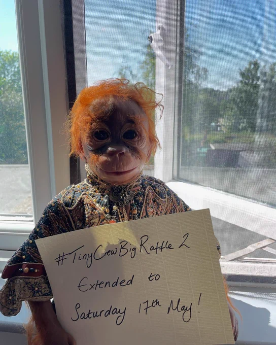The monkey you can win in Tiny Crew Big raffle 2 holding a sign that says Tiny Crew Big Raffle 2 Extended to Saturday 17th May!