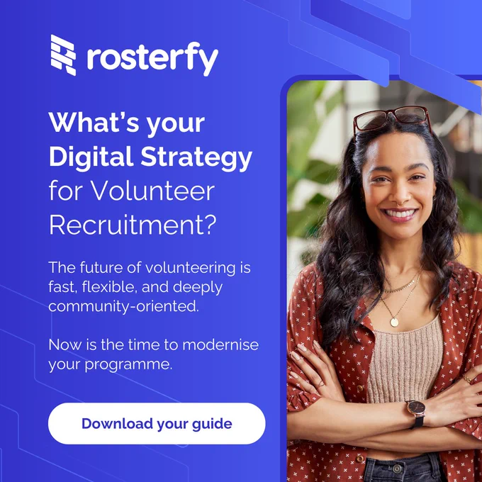 Advertisement for Rosterfy featuring a smiling woman with long dark hair, wearing a red patterned shirt and glasses on her head. The text reads: 'What’s your Digital Strategy for Volunteer Recruitment? The future of volunteering is fast, flexible, and deeply community-oriented. Now is the time to modernise your programme.' A button at the bottom says 'Download your guide'.