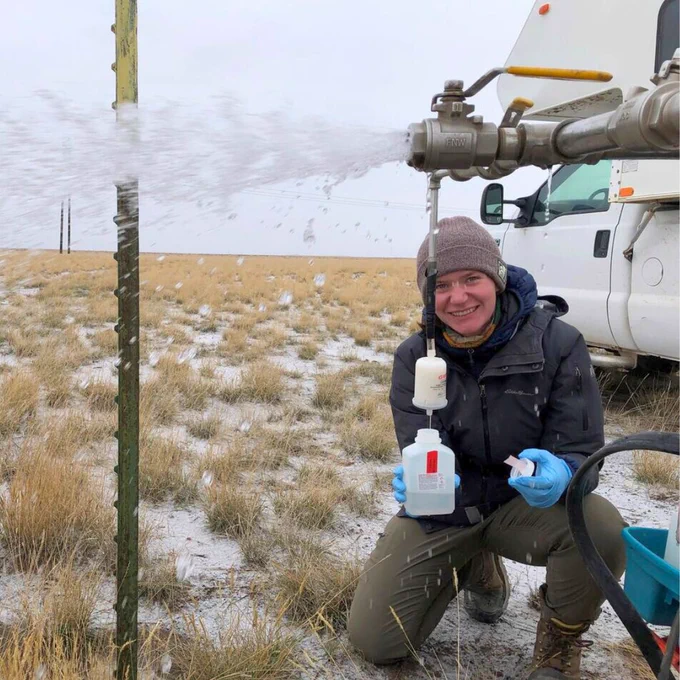 A USGS hydrologist collects a groundwater sample at the Idaho National Laboratory. 