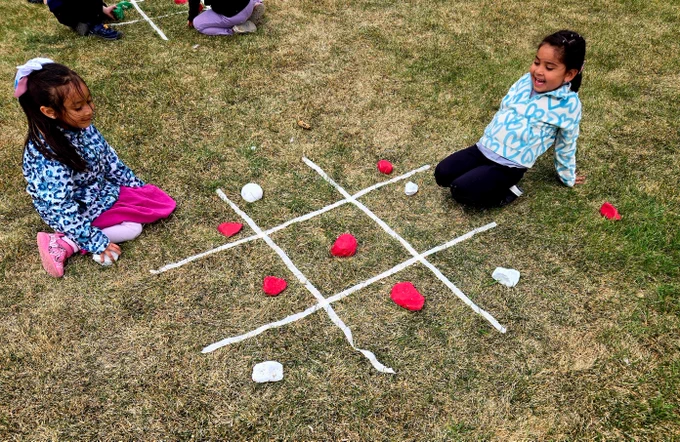 Students playing tic tac toe. 