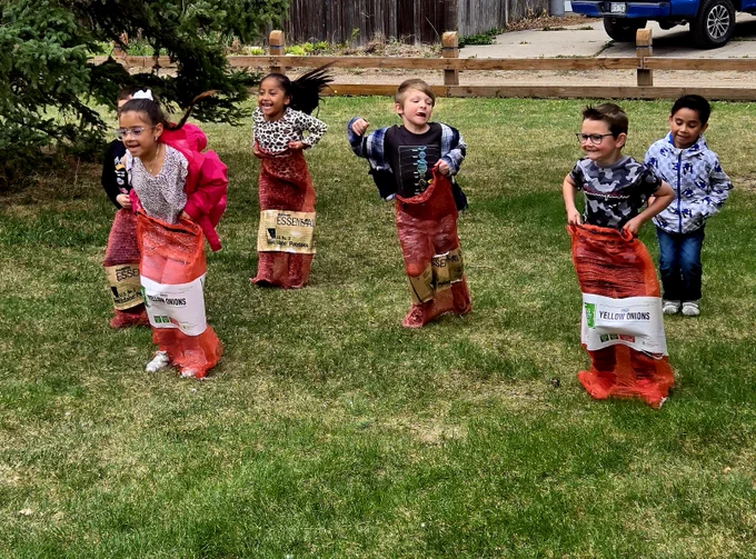Students doing a potato sack race. 