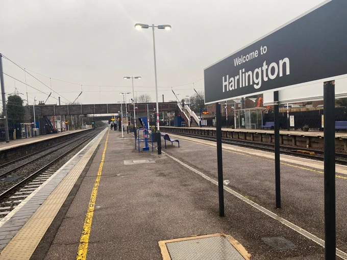 Harlington station as is now. Footbridge in the distance with a station sign right of the photo