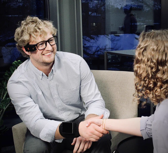 Person wearing ALeye while shaking a work colleague’s hand