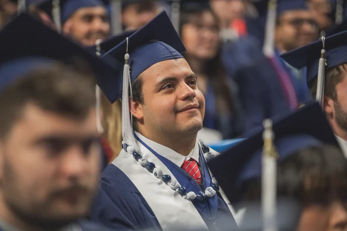 Grad looking on at commencement 
