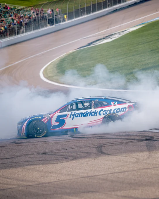 A photo of Kyle Larson celebrating his victory at Kansas Speedway in 2025. 