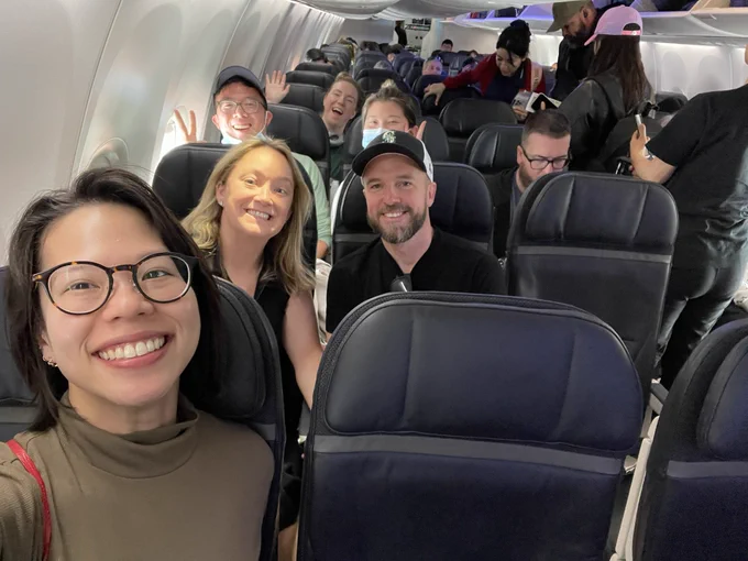 Four rows with people sitting on the plane.