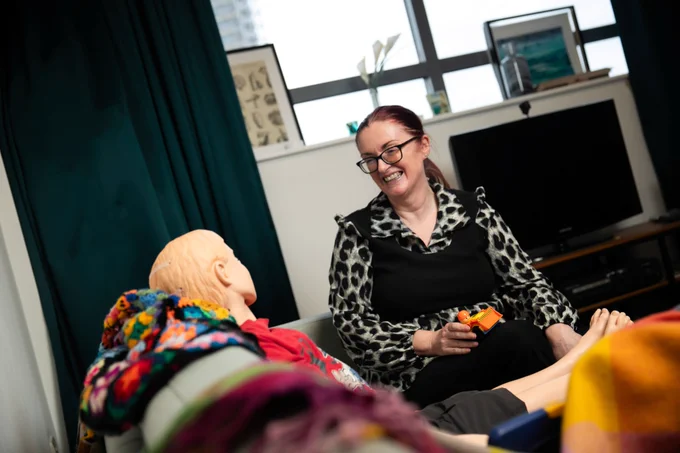 Michelle, a Community Nurse Specialist Practitioner apprentice with a simulator mannekin 