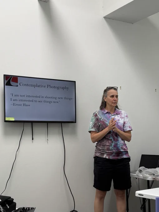 Denise Bossarte teaching in front of a television with a powerpoint presentation