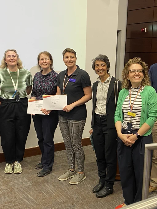 Thew Ways to Wellness team hold up their certificate. 