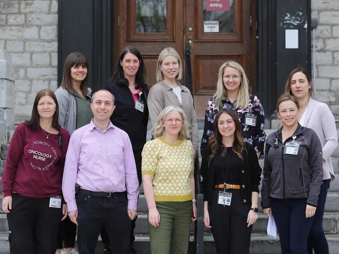 The team involved with making CAR T-cell therapy available at Kingston Health Sciences Centre poses for a photo outside Watkins Wing at Kingston General Hospital on Monday, May 5, 2025. Back row, from left: Brittany Somers and Julie Williams, registered nurses; Charlotte Holmgren, nurse practitioner; Renee Hartzell, program operational director – cancer care; Anastasia Miron, quality assurance manager – oncology. Front row, from left: Angie Bauder, registered nurse, Dr. Troy Climans and Dr. Annette Hay, hematologists; Christine Brown, program manager – oncology; and Rya MacKenzie, clinical learning specialist. Photo by Meghan Balogh /The Whig-Standard