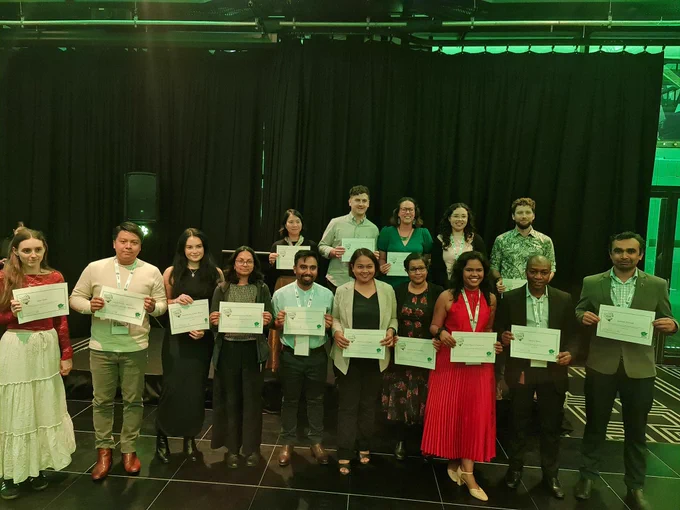 Student awardees with certificated standing in two rows. 