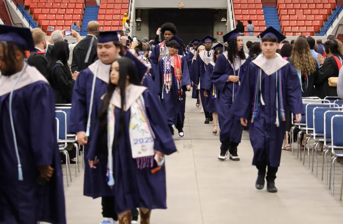 Graduates process in during their graduation ceremony.