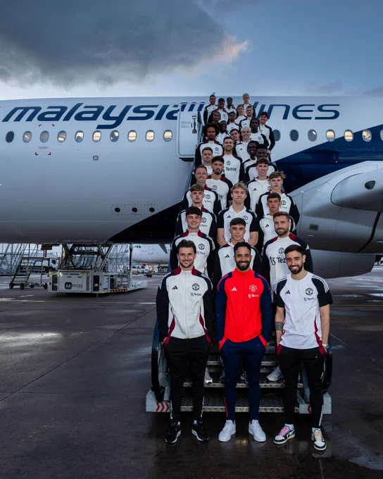 Manchester United pose in front of a Malaysia Airlines plane ahead of the tour of Asia.