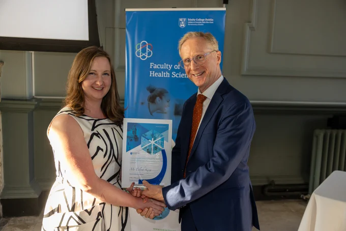 Eilish King receiving her award from the Dean of Health Sciences