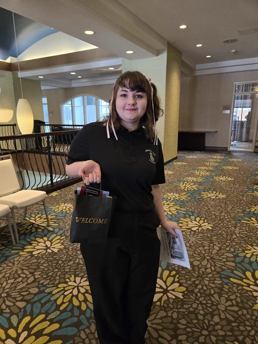Hospitality student hold welcome gift from Hilton.