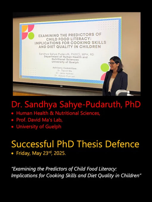 A photo of Sandhya at her defence, in front of a projected title screen with the same title of her thesis that is listed in this posting.