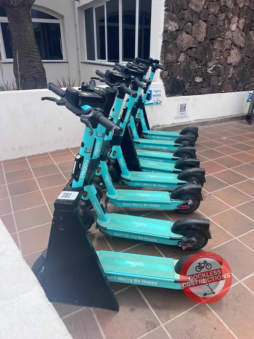 Row of e-scooters in a docking station on the Canaria Island of Fuerteventura.