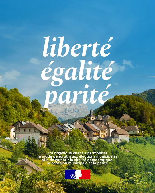 Visuel. À l'arrière plan, le village du Châtelard en Savoie.
Texte : liberté, égalité parité. Loi organique  visant à harmoniser le mode de scrutin aux élections municipales afin de
garantir la vitalité démocratique, la cohésion municipale et la parité.