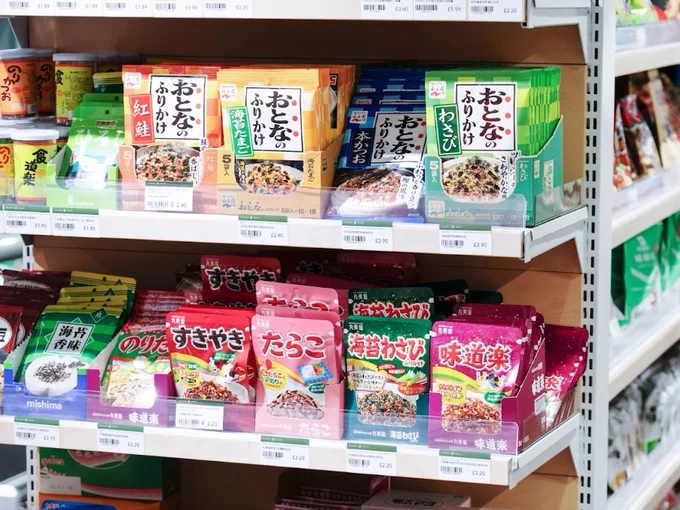 Shelves stocked with various Japanese food products, including noodles and soup mixes in colourful packaging.