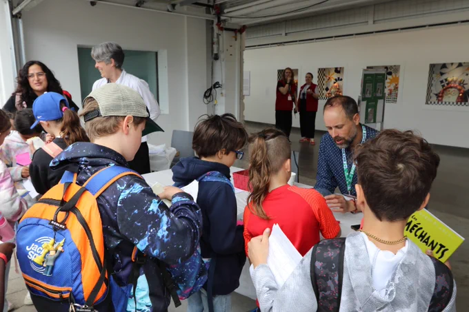 Young readers getting their autograph booklets signed at the Fête de la Forêt de la lecture by an award winner.