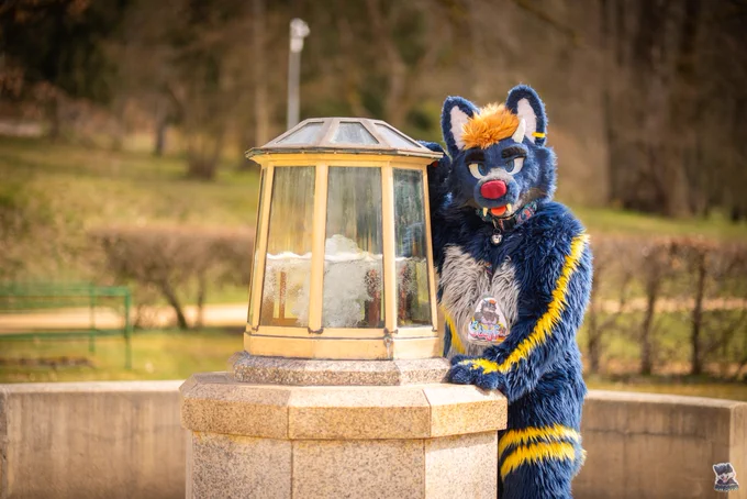 Me in suit next to an incased fountain.