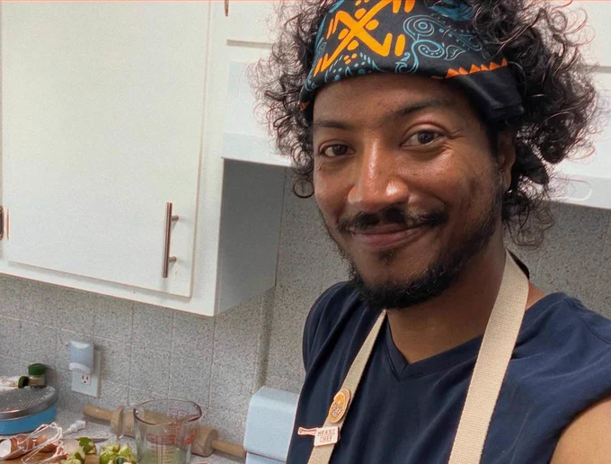 Samba Schutte in an apron and bandana making key lime pie for the class