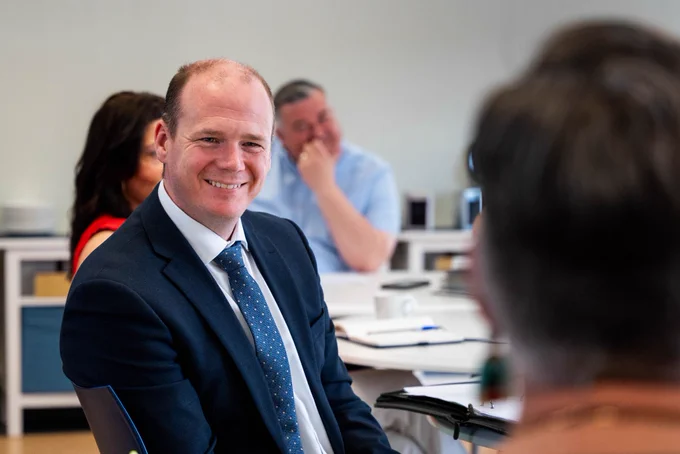 Minister Lyons smiling.