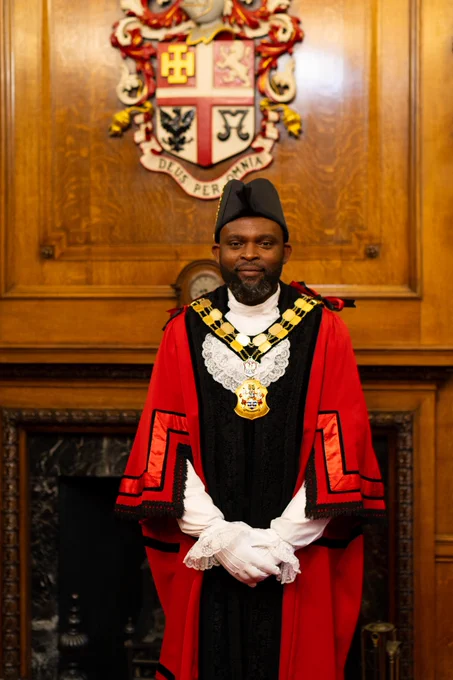 Image of Mayor of Islington, Cllr Jason Jackson in red ceremonial robes standing in the Mayor's Parlour.