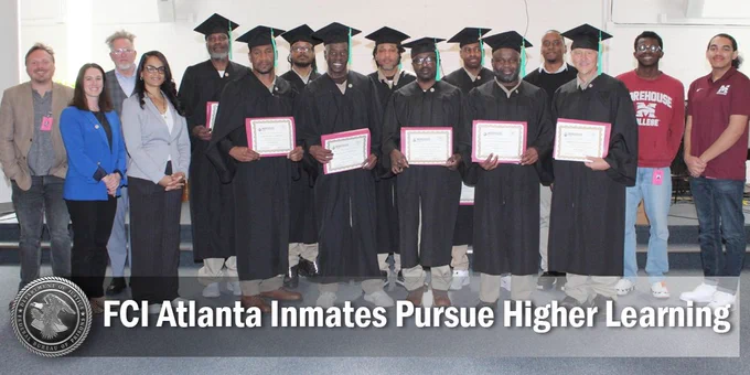 Group of individuals graduating from a program at FCI Atlanta, holding certificates and smiling, accompanied by several instructors.