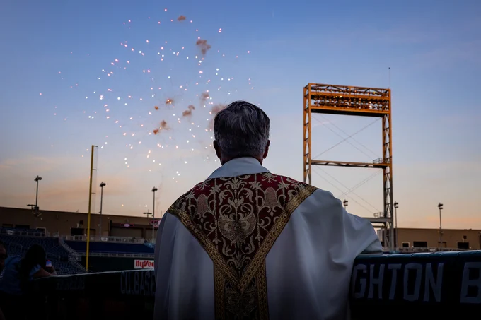 Creighton University President the Rev. Daniel S. Hendrickson, SJ, PhD, looks out at fireworks.