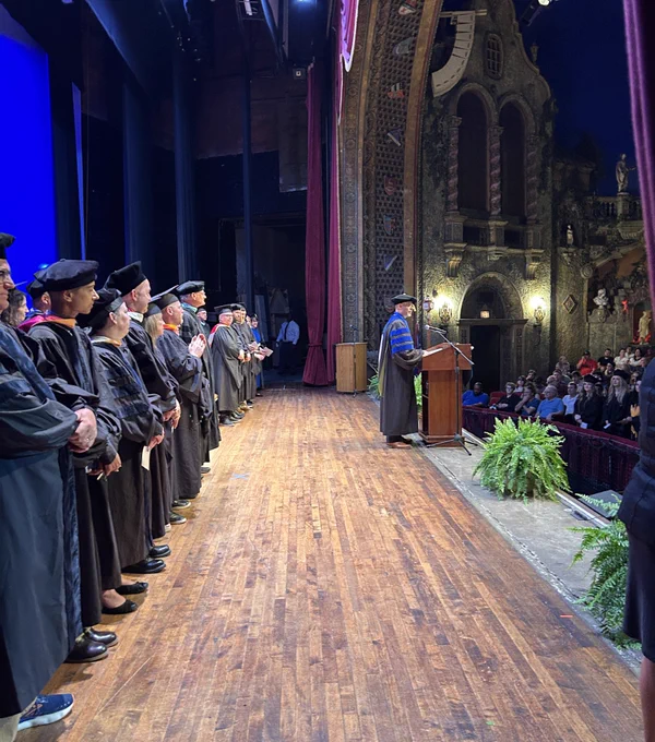 The president stands at a podium on stage.