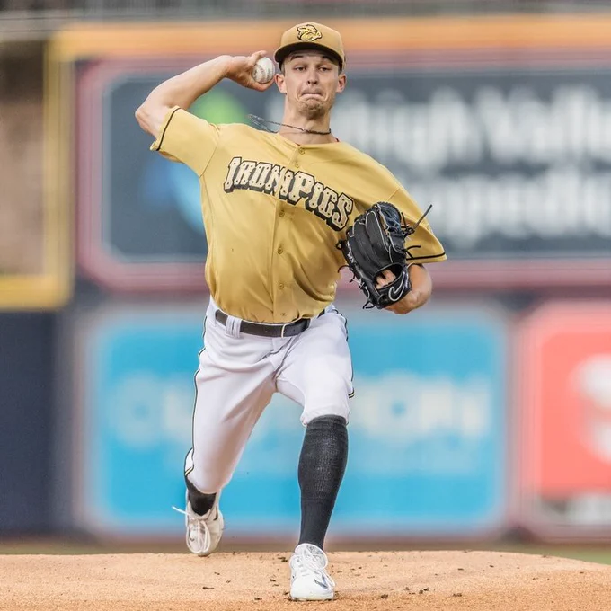 Photo of Mick Abel throwing a pitch in a gold Iron Pigs jersey