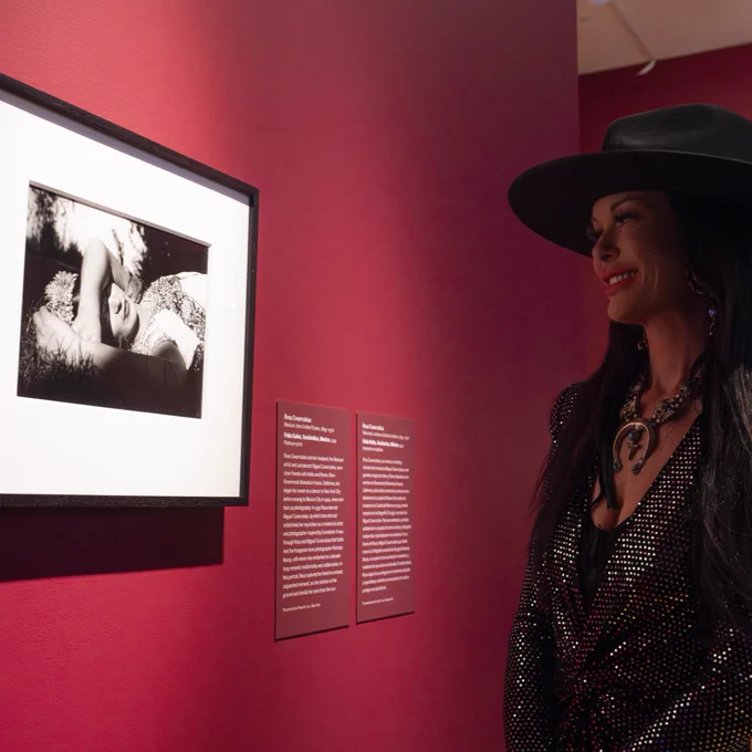 A museum visitor views a photograph of Frida Kahlo in VMFA's special exhibition "Frida: Beyond the Myth."