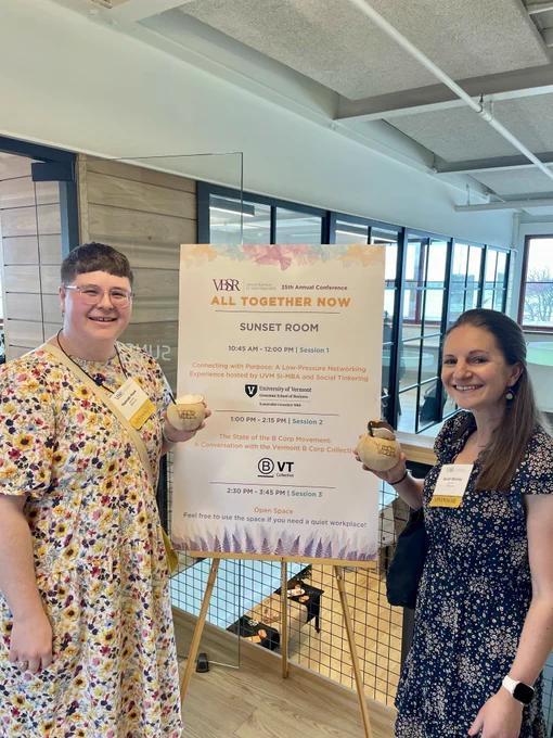 Hannah and Sarah at the 2025 VBSR conference holding coconut drinks
