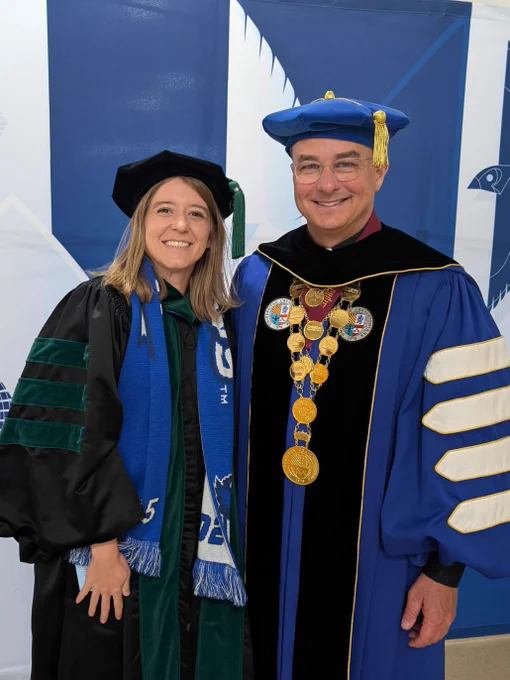 The Rev. Daniel S. Hendrickson, SJ, PhD, stands with Allie Jones, a recent Creighton School of Medicine alumna
