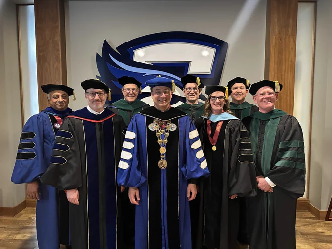 Creighton University President the Rev. Daniel S. Hendrickson, SJ, PhD, stands with members of the SOM faculty.