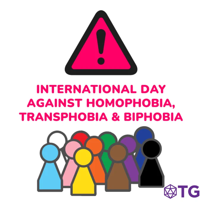 A magenta title reading "International Day Against Homophobia, Transphobia & Biphobia." Above it is a black exclamation mark on a magenta triangle. Below it are the Tabletop Gaymers logo and a collection of board-game pieces in the color of the progress pride flag. 