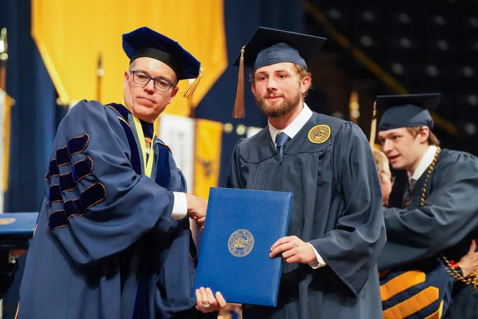 Noah Johnson receives his diploma.